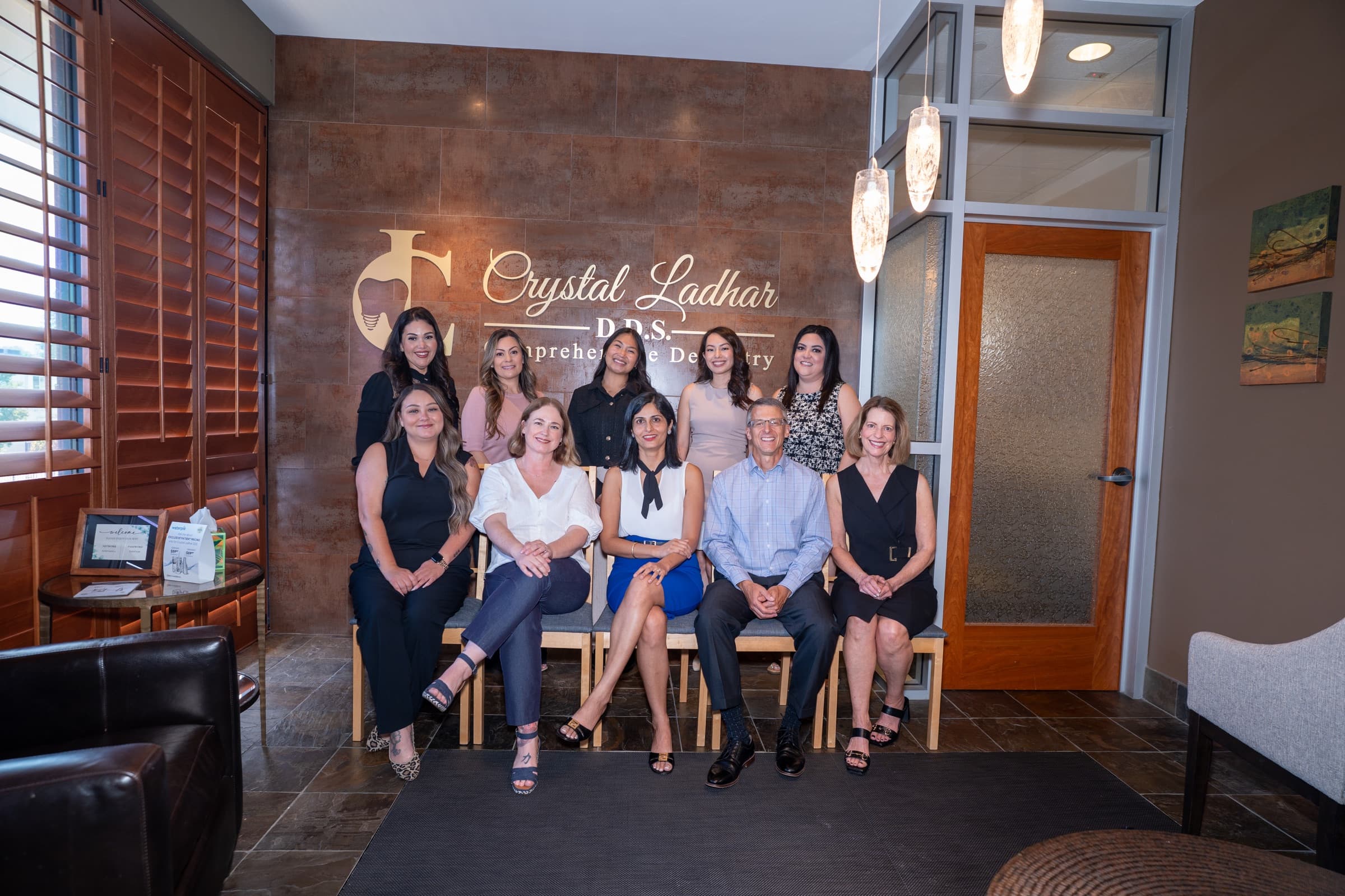 The Crystal Ladhar D.D.S. team seated together in the practice reception